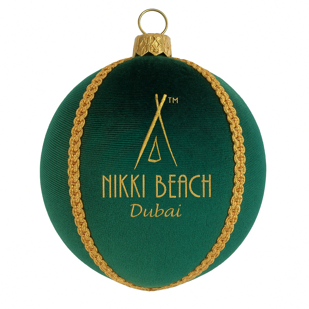 Green ornament with gold trim featuring 'Nikki Beach Dubai' on a white background