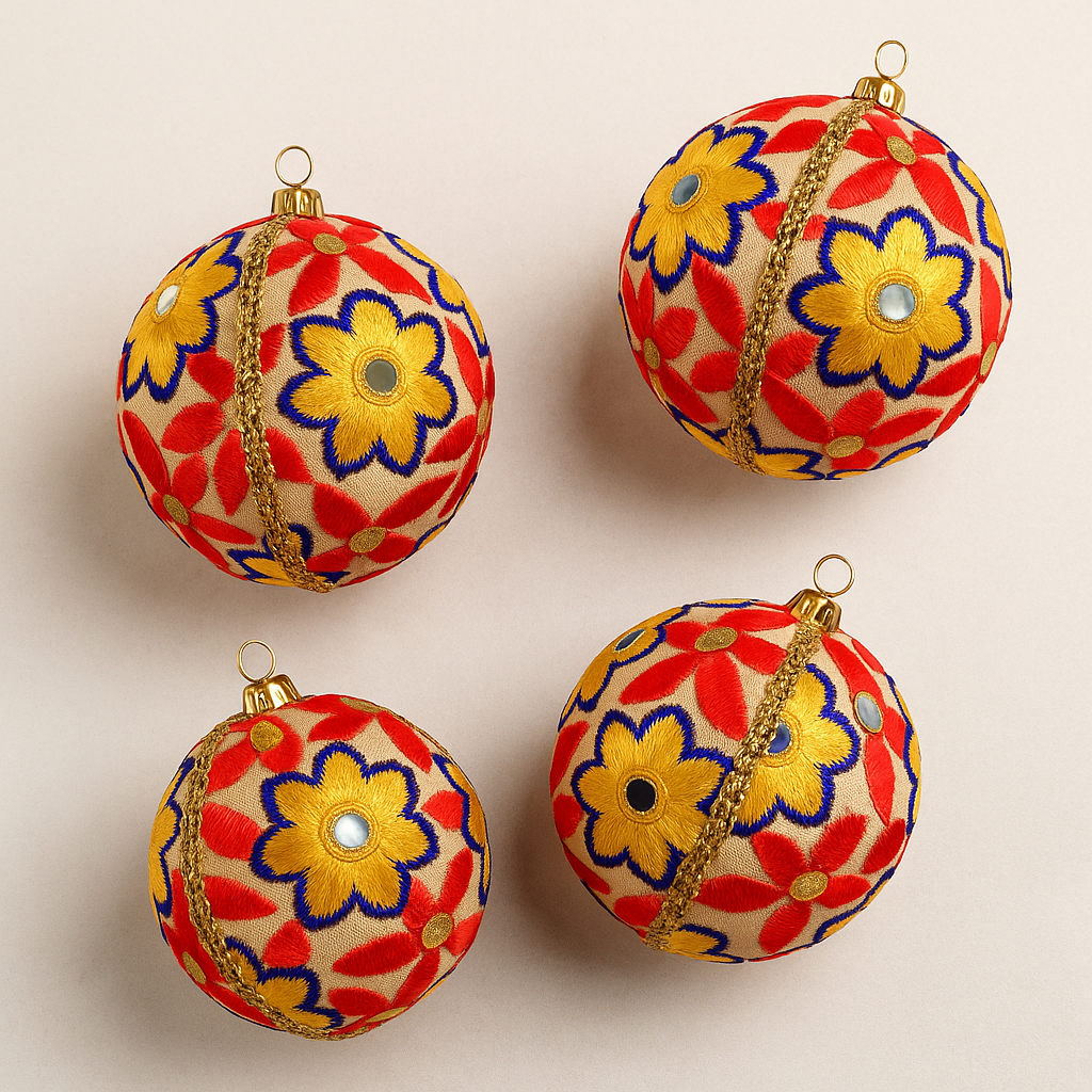 Four colorful Advik floral-patterned Christmas ornaments on a beige background