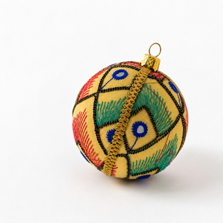 Aarav handmade fabric bauble, 8cm, soft cream ground with hand-embroidered peacock-inspired motifs in red, blue and green threadwork with mirror-work detail.