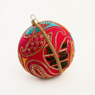 Aditi handmade fabric bauble, 10cm, hot pink ground with large sweeping gold paisley cordwork with dense magenta satin stitch and multicolour panels.