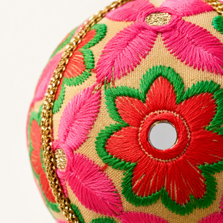 A cluster of Advik handmade fabric baubles, 10cm, grouped to show the large-scale hand-embroidered daisy and sunflower motifs with shisha mirror centres.