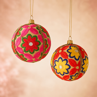 Advik fabric bauble held in hand, highlighting the scale and sustainable, reclaimed-textile craftsmanship of this 10cm bauble.