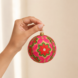 Advik bauble detail shot, a 10cm UK-made sustainable ornament with warm cream ground and large-scale hand-embroidered daisy and sunflower motifs with shisha mirror centres.