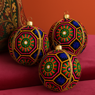 Ananya Bauble – 10cm black fabric ornament with multicolour geometric embroidery, mirrorwork, and gold braid, handmade in the UK.