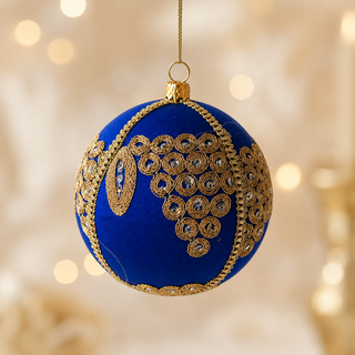 Arjun fabric bauble held in hand, highlighting the scale and sustainable, reclaimed-textile craftsmanship of this 10cm bauble.