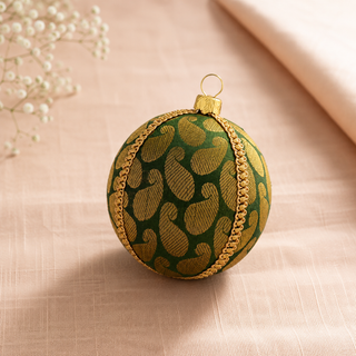 Charu bauble detail shot, an 8cm UK-made sustainable ornament with forest green ground and a bold gold woven paisley brocade with a gold chain braid trim.