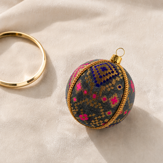 A cluster of Chirag handmade fabric baubles, 8cm, grouped to show the dense gold checkerboard pattern lifted by magenta and cobalt blue accents.