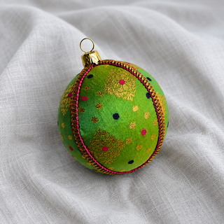 A cluster of Jaya handmade fabric baubles, 8cm, grouped to show the gold diamond-lattice motifs with playful pink and navy dots.