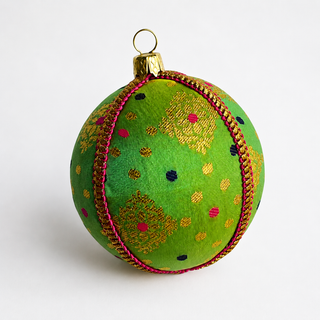 Jaya handmade fabric bauble, 8cm, vivid green ground with gold diamond-lattice motifs with playful pink and navy dots.