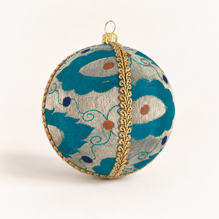 A spherical decorative ornament featuring a teal and silver patterned fabric body with gold trim and a gold hanging loop, shown on a clean off-white background.