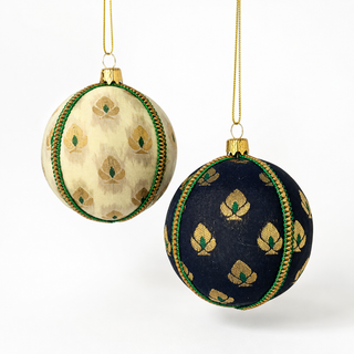 Kamla handmade fabric bauble, 8cm, soft cream (also in black) ground with a delicate gold floral motif with green accents and a green-and-gold cord trim.