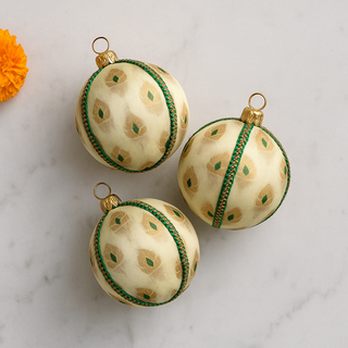 Set of Kamla Baubles in cream with gold and green details, luxury handmade decorations.