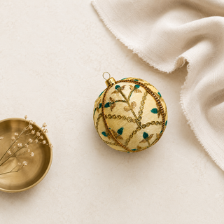A cluster of Lalit handmade fabric baubles, 10cm, grouped to show the delicate gold floral embroidery with teal thread accents and a metallic gold trim.