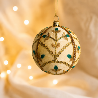 Lalit fabric bauble held in hand, highlighting the scale and sustainable, reclaimed-textile craftsmanship of this 10cm bauble.