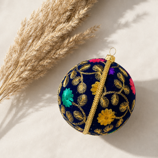 A cluster of Mahir handmade fabric baubles, 10cm, grouped to show the fine gold fern-leaf embroidery with scattered pink, purple and teal florals.