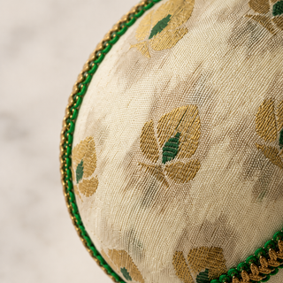 Kamla fabric bauble held in hand, highlighting the scale and sustainable, reclaimed-textile craftsmanship of this 8cm bauble.