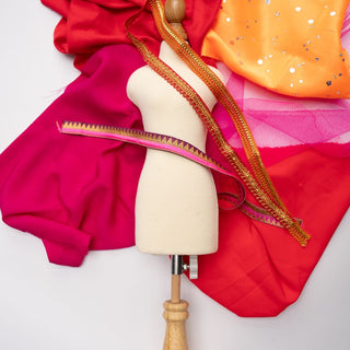Mashquin mannequin with a flat lay of fabrics and trims from the Mashquin booster pack 