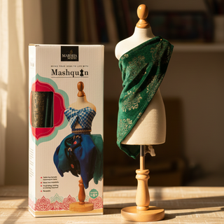 Manniquin with Mashquin box with a dressed mannequin in a green fabric 