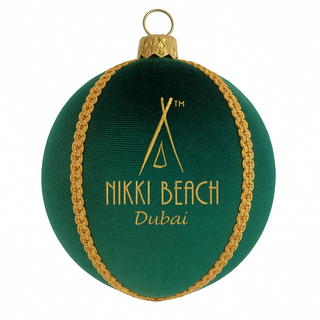 Green ornament with gold trim featuring 'Nikki Beach Dubai' on a white background