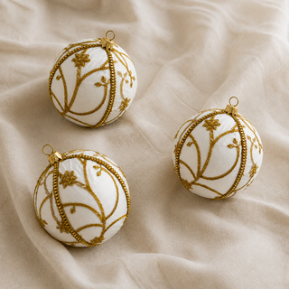 Shashi fabric bauble held in hand, highlighting the scale and sustainable, reclaimed-textile craftsmanship of this 10cm bauble.