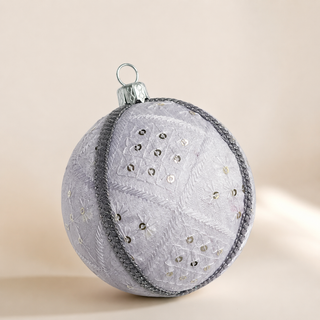 Snow Queen handmade fabric bauble, 10cm, white ground with a diamond-quilted stitch pattern with delicate starburst embroidery, scattered sequins and a silver cord trim.