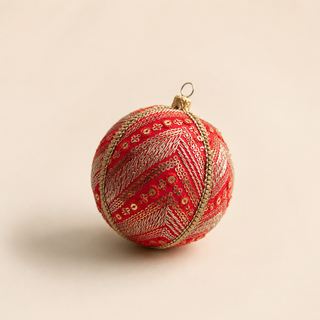 Subhash handmade fabric bauble, 8cm, deep red silk ground with diagonal bands of gold and silver embroidery with scattered sequin florets and a beaded gold trim.