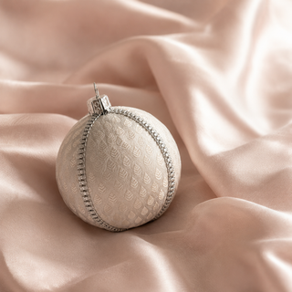 A cluster of Surya handmade fabric baubles, 8cm, grouped to show the woven brocade leaf motif with a fine silver diamanté trim.