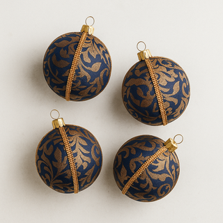 Four blue and gold patterned Christmas ornaments on a light gray background. Luxury handmade bauble in deep blue and gold baroque, sustainable ornament for Christmas, weddings, and home styling.