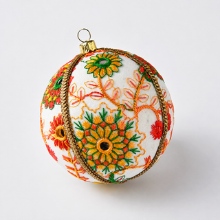 Vanika handmade fabric bauble, 8cm, cream ground with embroidered floral medallions in orange, yellow, green and red with mirror-work centres and a gold cord trim.
