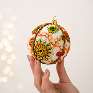 A cluster of Vanika handmade fabric baubles, 8cm, grouped to show the embroidered floral medallions in orange, yellow, green and red with mirror-work centres and a gold cord trim.