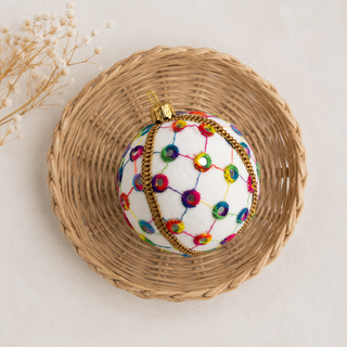 Vikram fabric bauble held in hand, highlighting the scale and sustainable, reclaimed-textile craftsmanship of this 8cm bauble.