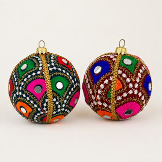 Vivaan handmade fabric bauble, 8cm, deep teal (also in maroon) ground with densely embroidered peacock-feather motifs in green, pink, orange and blue with mirror-disc centres.