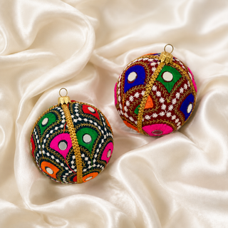 Vivaan fabric bauble held in hand, highlighting the scale and sustainable, reclaimed-textile craftsmanship of this 8cm bauble.