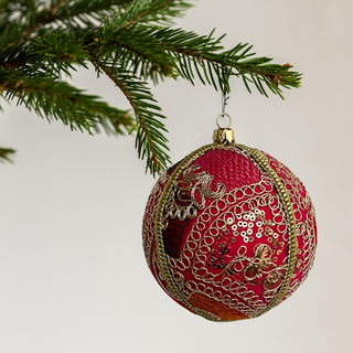 Close-up embroidery detail of the Aarna Bauble with gold accents and sequin work