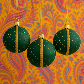 Akansh Baubles hanging against a vibrant paisley yellow backdrop, highlighting the bold green and gold design with a fun, colourful twist.