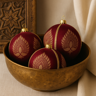 A trio of Anant Baubles nestled in a vintage brass bowl with carved wood accents, adding a subtle Indian touch to this elegant home decor image.