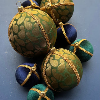 Close-up of Charu Bauble showing gold paisley brocade texture and metallic braid trim.