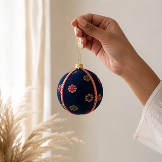 Dancing Florals fabric bauble held in hand, highlighting the scale and sustainable, reclaimed-textile craftsmanship of this 8cm bauble.