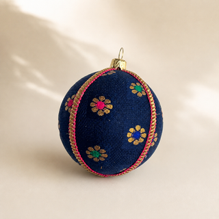 Dancing Florals handmade fabric bauble, 8cm, deep navy ground with scattered gold flower motifs with jewel-tone pink, green and blue centres.