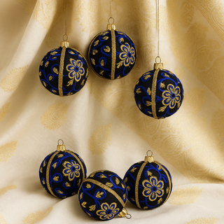 Ishana Bauble – 8cm black fabric ornament with royal-blue and gold floral embroidery and gold braid, handmade in the UK.