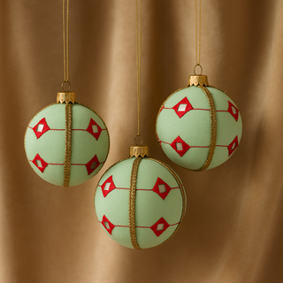 Kalinda baubles in three hanging agains a beige backdrop 