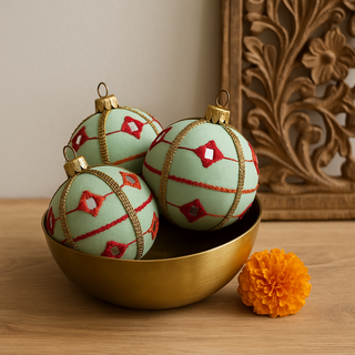 Kalinda baubles in set of three in a brass bowl, with a stunning wooden carving and a delicate marigold. 