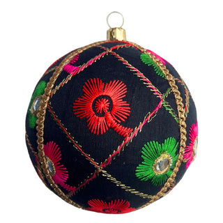 Single Kalyani bauble cut out to see the detail. Kalyani Bauble – 10cm handmade fabric ornament in black with pink, green & red embroidery and mirror accents, luxury sustainable décor.