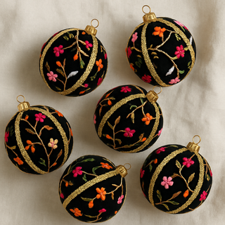 Keshiv Bauble – 10cm black velvet ornament with vibrant floral embroidery and gold trim, handmade in the UK.