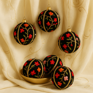 Close-up of Keshiv Bauble showing multicoloured floral threads on black velvet fabric