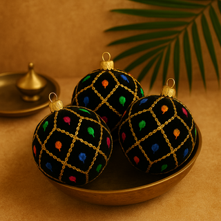 Three Kimaya Baubles in 8cm nestled inside a brass bowl, set against a warm neutral background with a palm leaf, brass tray, and diya for a subtle Indian-inspired feel.