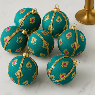 Kush Bauble – 8cm teal brocade ornament with gold and pink lotus motifs, finished with gold braid trim, handmade in the UK.