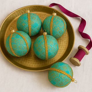 Lakshmanji Bauble – 8cm soft blue and gold brocade ornament with floral motifs and gold braid trim, handmade in the UK.