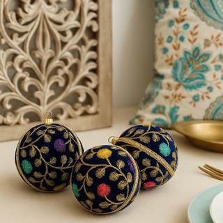 Trio of Mahir Baubles placed casually on a marble-top table beside a carved wooden panel and block-print cushion, blending Indian charm with modern styling.