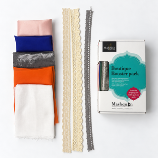Rainbow Kaleidoscope Mashquin booster pack example: blush pink, royal blue, silver, orange and white fabrics with lace and crochet trims beside the booster pack box